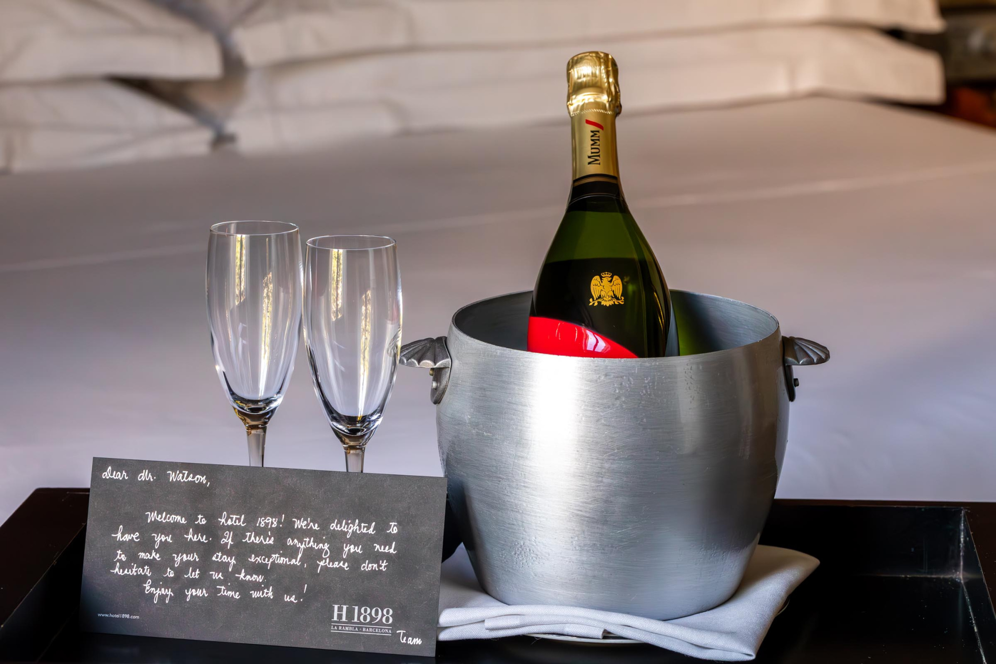 Una elegante botella de champagne con una etiqueta dorada y detalles en negro, presentada en un entorno que resalta su lujo y sofisticación.