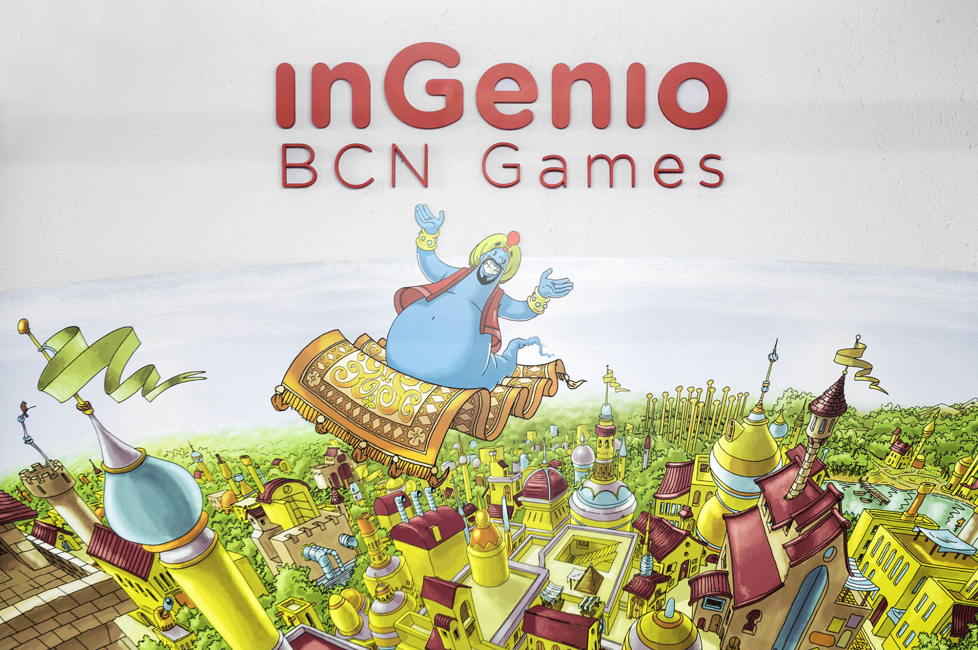 Ilustración con el texto “inGenio BCN Games” y un personaje sobre un paisaje colorido.